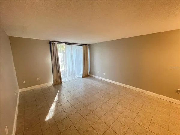 a view of an empty room and a window