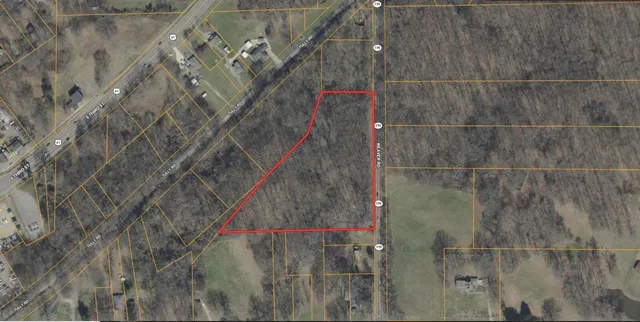 a bathroom with a shower and a tiled wall