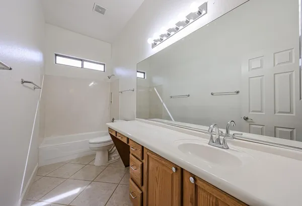 a view of a kitchen with refrigerator and a sink