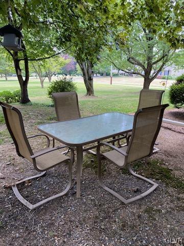 560 Cherry Hill Road Nazareth, PA 18064 - Photo 40 of 48 a view of a backyard with table and chairs potted plants and a large tree
