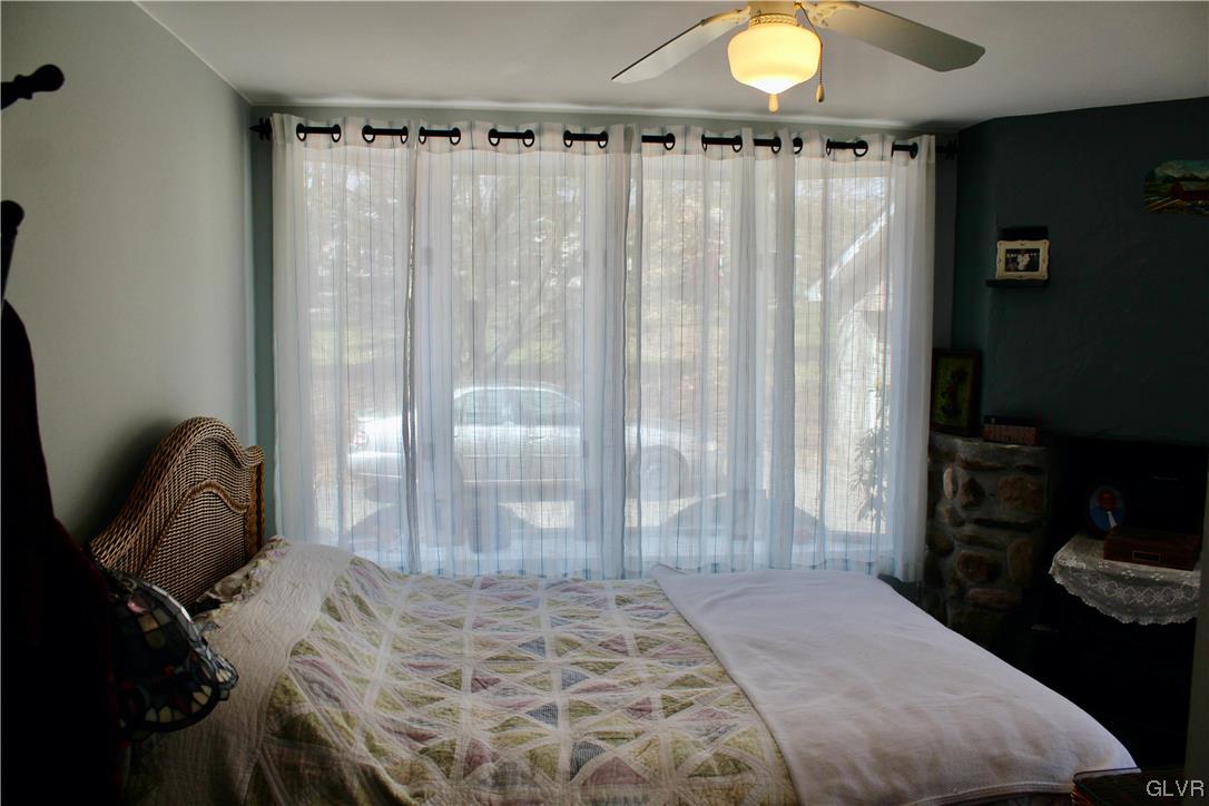 560 Cherry Hill Road Nazareth, PA 18064 - Photo 4 of 48 a bedroom with a bed and a chandelier