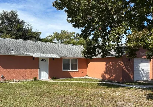 a view of a house with a backyard