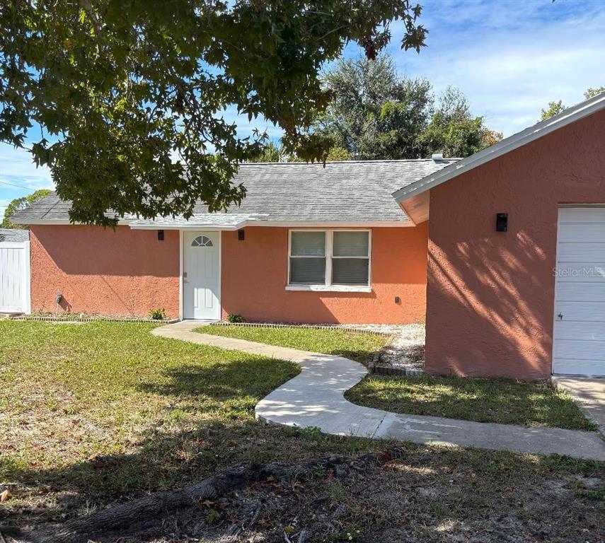 15827 Adobe Drive Hudson, FL 34667 - Photo 2 of 12 a front view of a house with garden