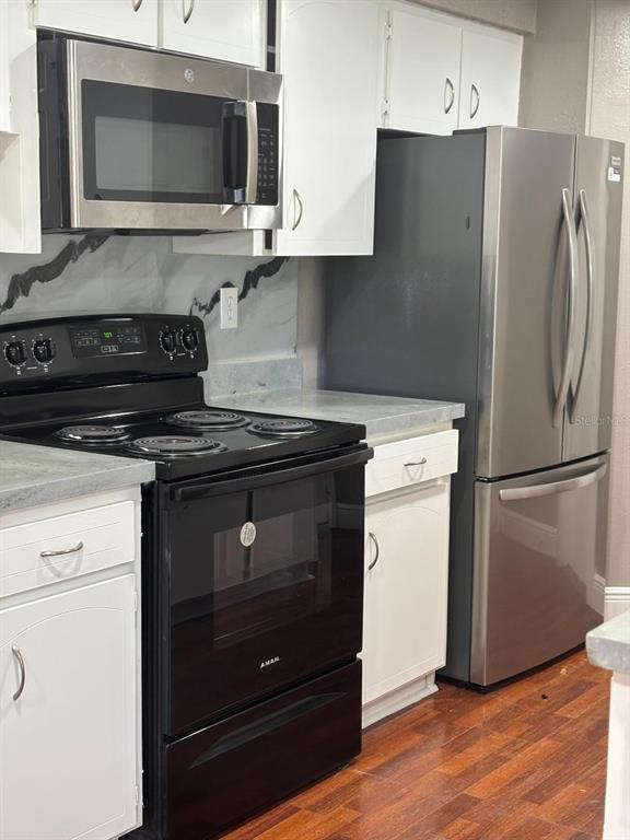 15827 Adobe Drive Hudson, FL 34667 - Photo 3 of 12 a kitchen with granite countertop cabinets and steel stainless steel appliances