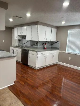 a kitchen with granite countertop a stove and a sink