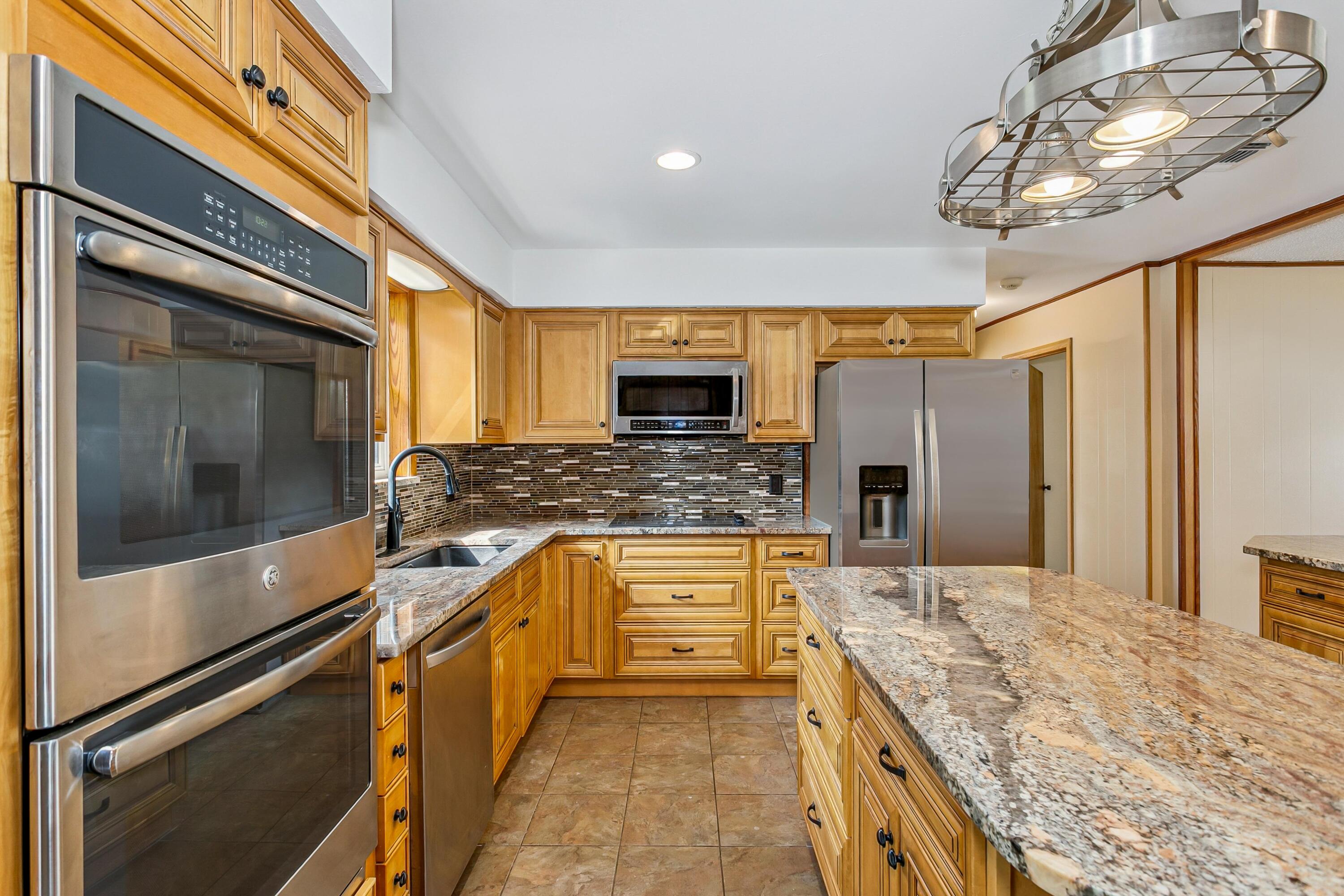 3146 Forrest Avenue Crestview, FL 32539 - Photo 12 of 47 a kitchen with stainless steel appliances granite countertop a sink and stove top oven