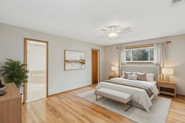 a bedroom with a bed and a potted plant