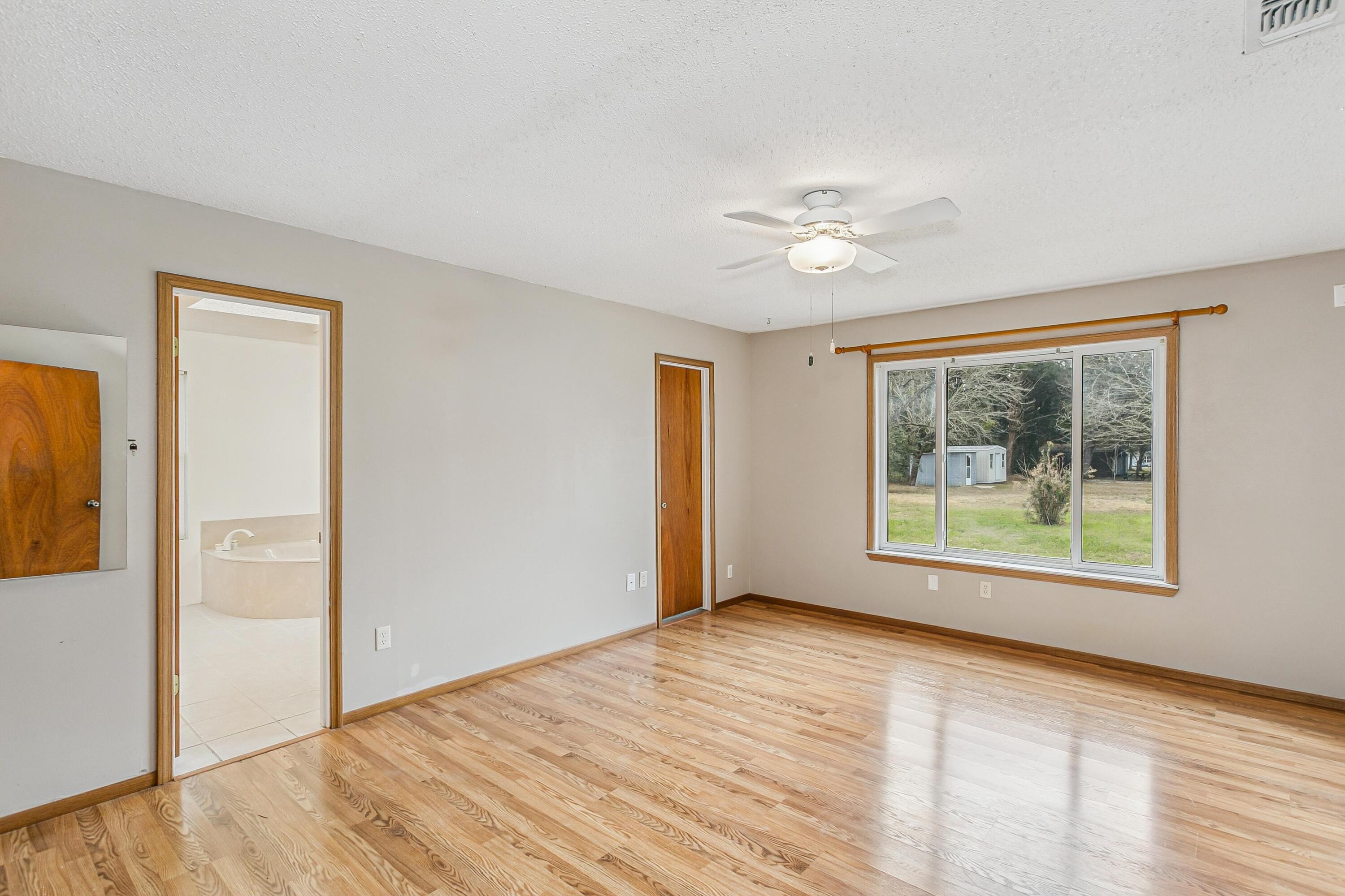 3146 Forrest Avenue Crestview, FL 32539 - Photo 17 of 47 wooden floor in an empty room with a window