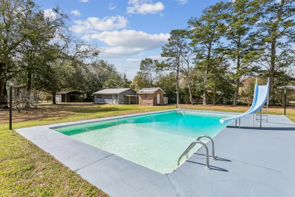a view of swimming pool with chairs