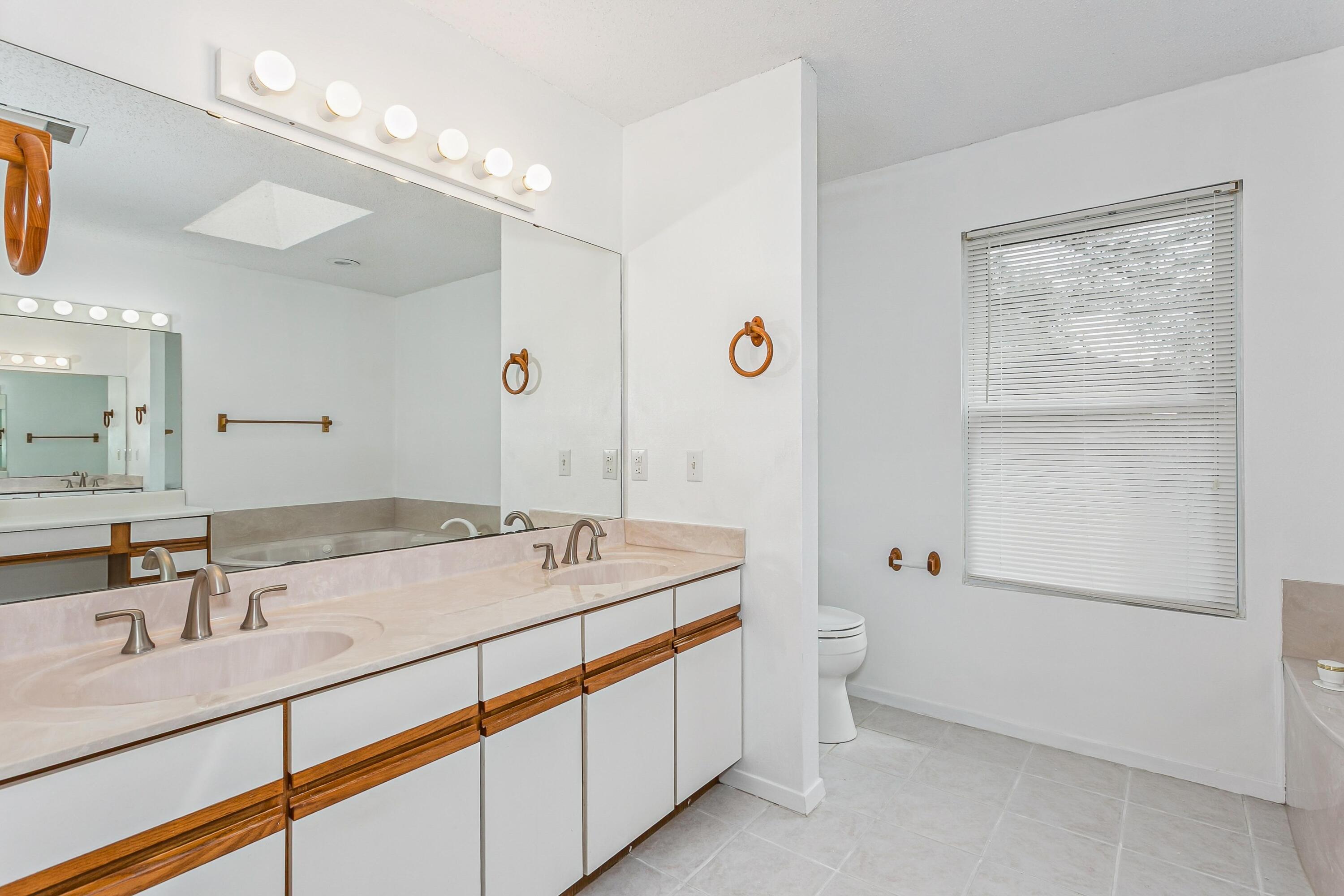 3146 Forrest Avenue Crestview, FL 32539 - Photo 21 of 47 a bathroom with a double vanity sink toilet and a mirror