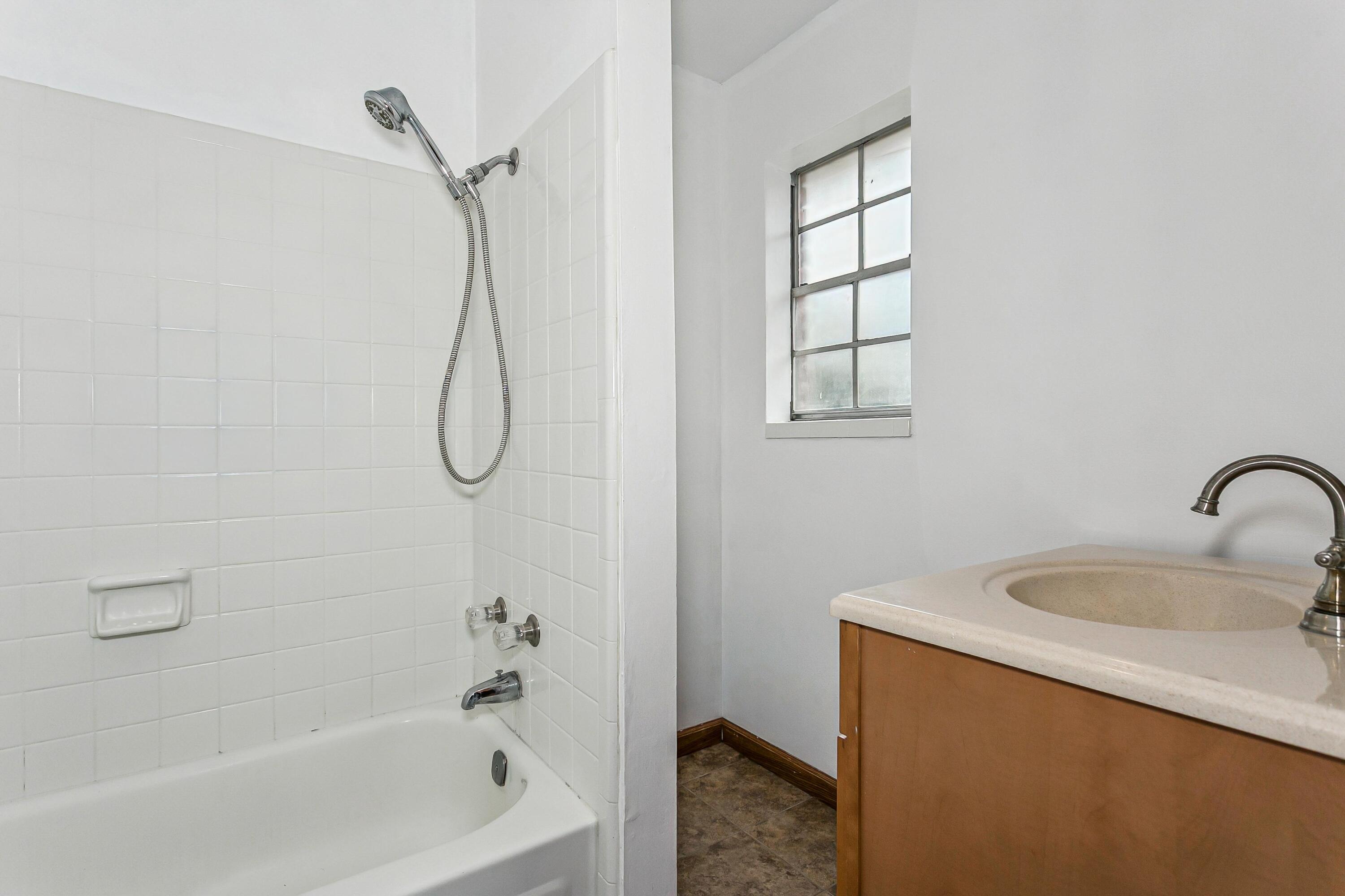 3146 Forrest Avenue Crestview, FL 32539 - Photo 24 of 47 a bathroom with a bath tub with a shower