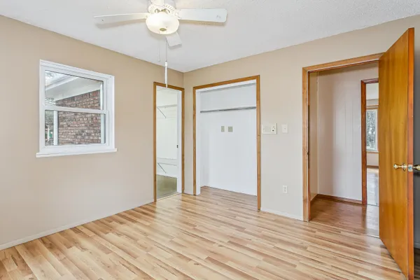 a view of empty room with wooden floor
