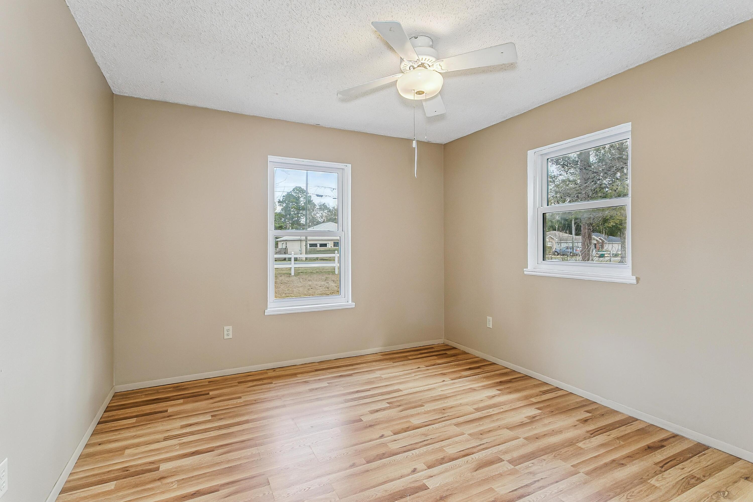 3146 Forrest Avenue Crestview, FL 32539 - Photo 28 of 47 a view of an empty room with wooden floor and a window