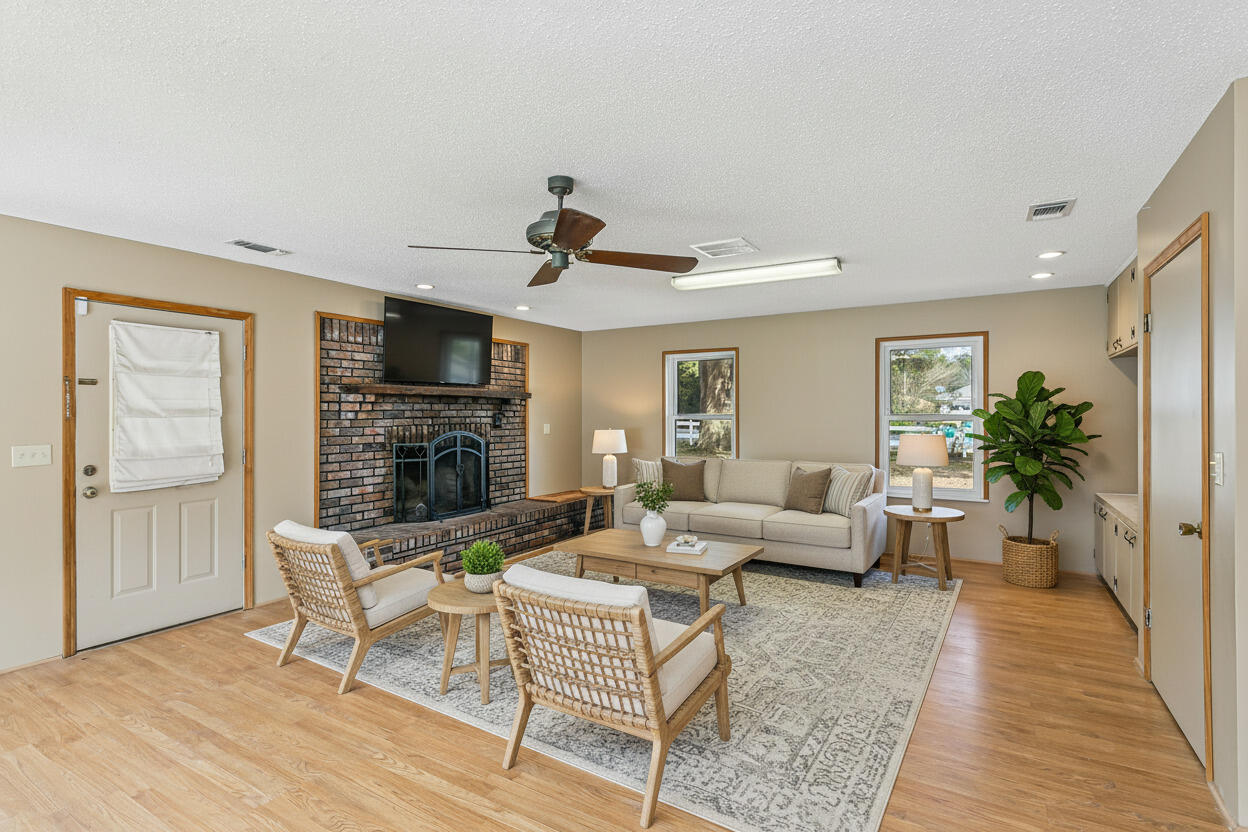 3146 Forrest Avenue Crestview, FL 32539 - Photo 30 of 47 a living room with furniture and a fireplace