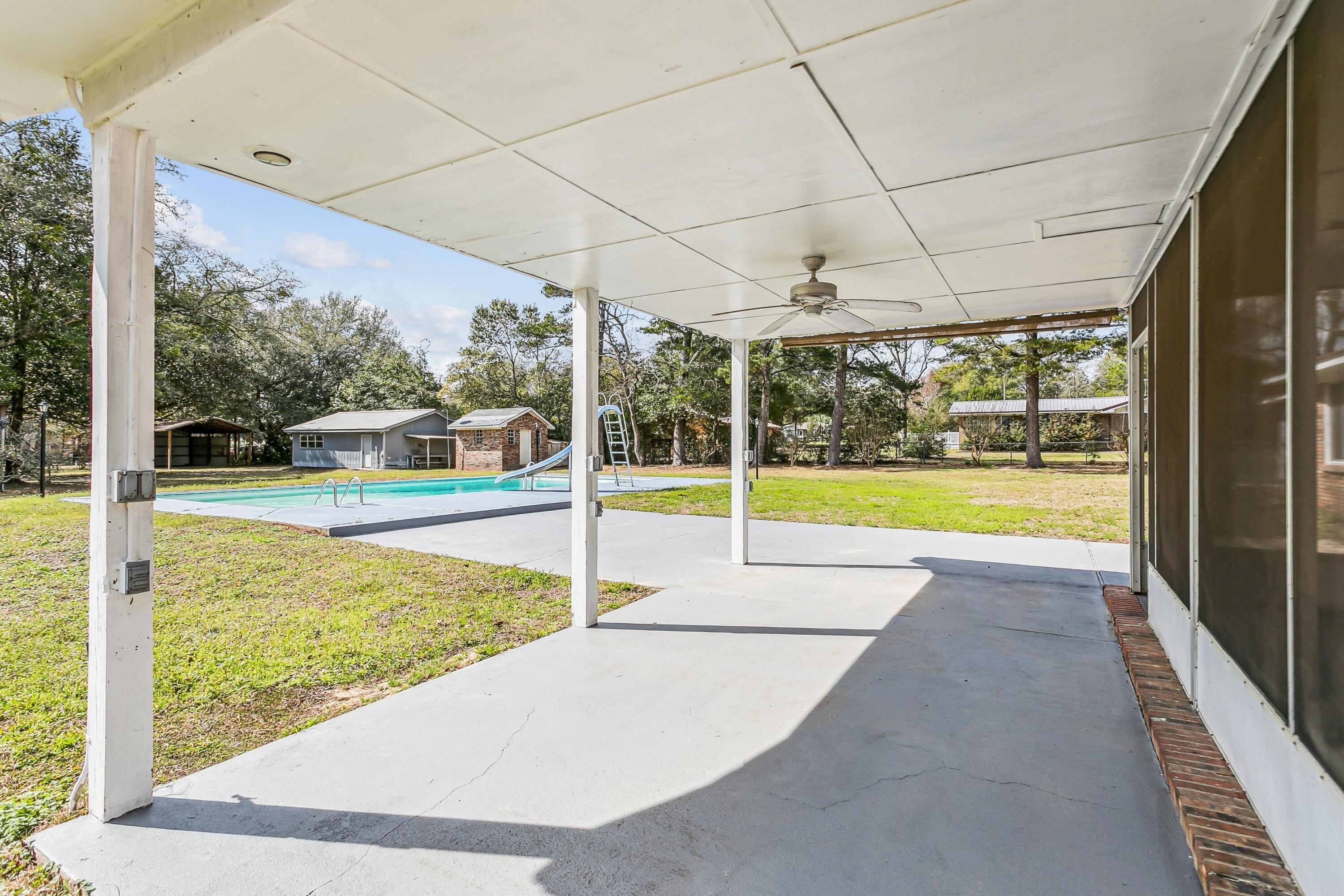 3146 Forrest Avenue Crestview, FL 32539 - Photo 38 of 47 a view of a swimming pool with a porch