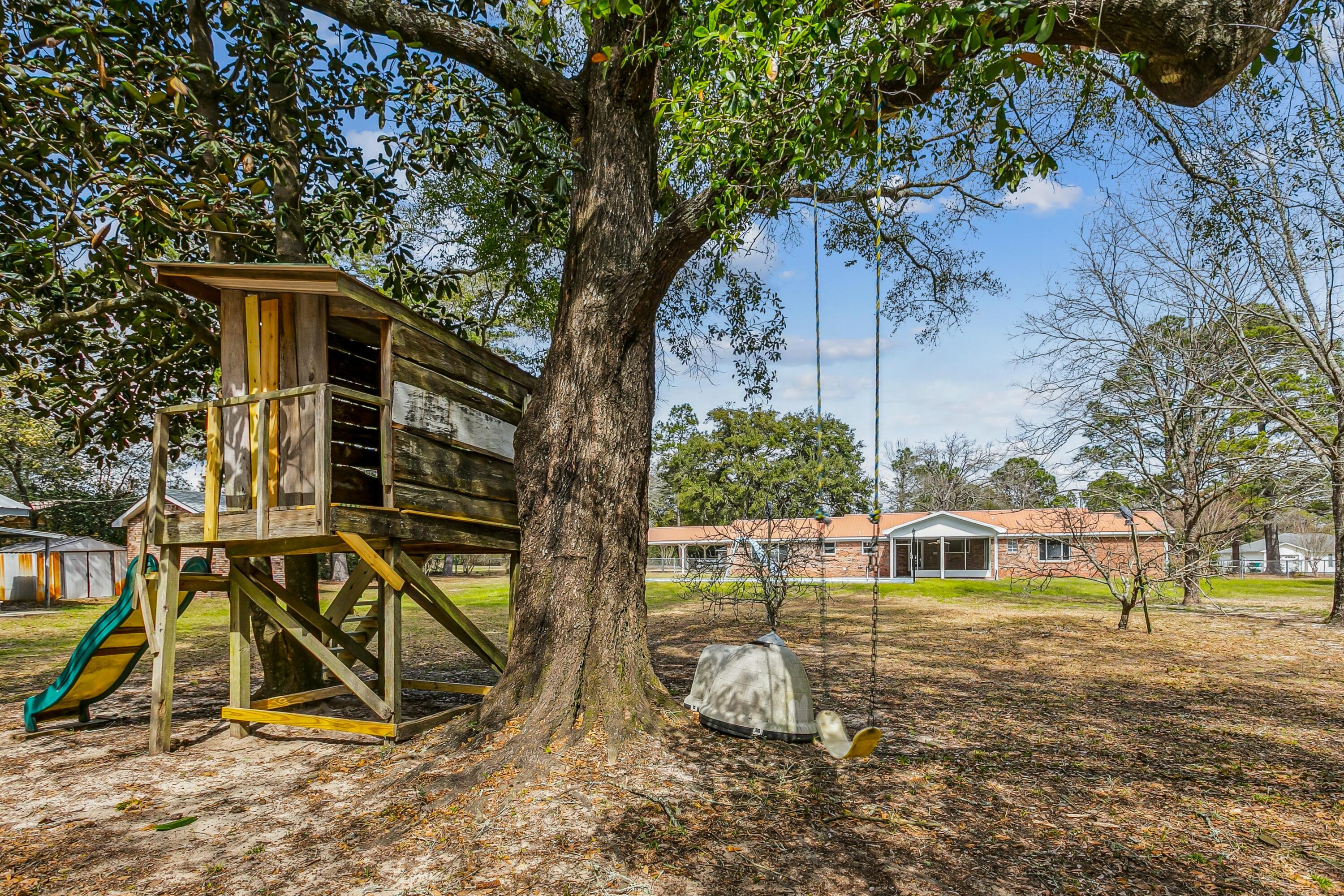 3146 Forrest Avenue Crestview, FL 32539 - Photo 39 of 47 a view of a backyard with a table and chairs
