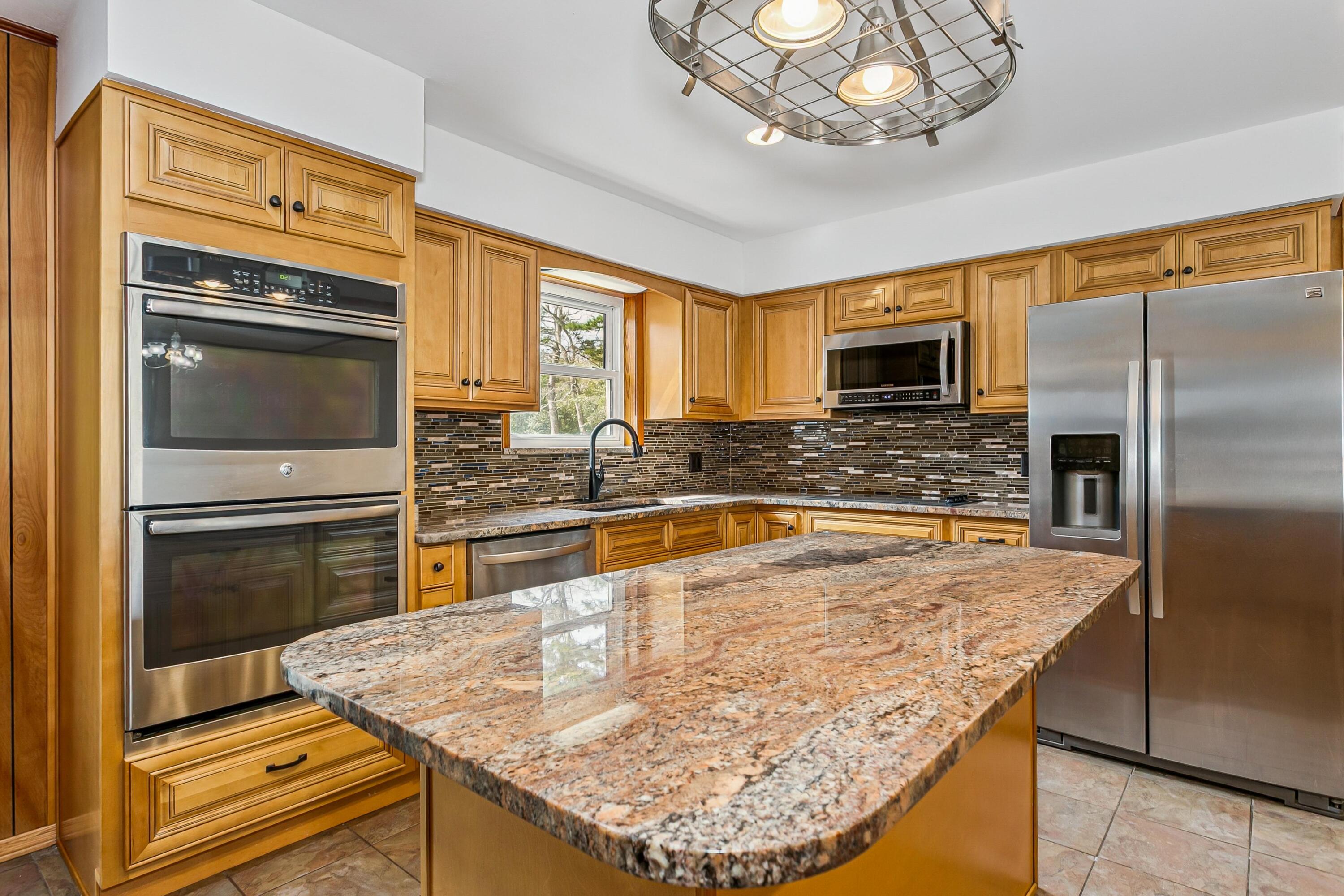 3146 Forrest Avenue Crestview, FL 32539 - Photo 6 of 47 a kitchen with a chandelier appliances and a counter top space