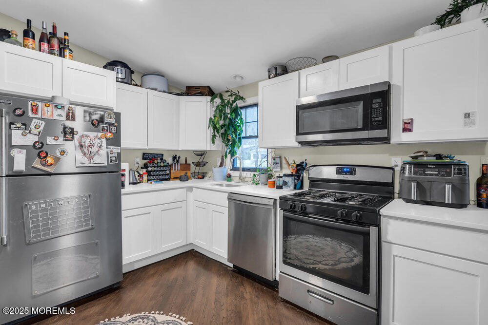 6 Mizzen Way Waretown, NJ 08758 - Photo 9 of 12 a kitchen with stainless steel appliances a stove microwave and sink