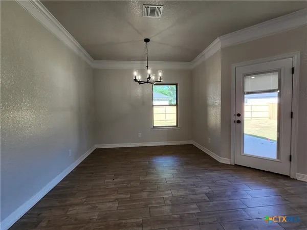 a view of a livingroom with a ceiling fan and window