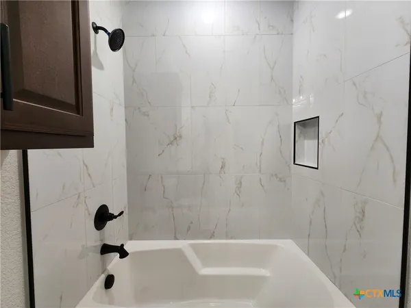 a spacious bathroom with a double vanity sink and mirror