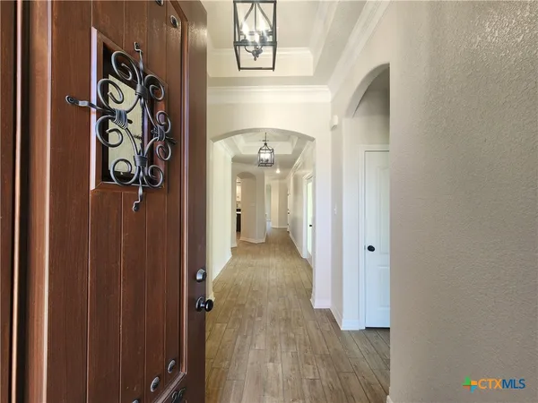a view of a hallway with wooden floor