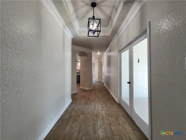 a view of a hallway with wooden floor