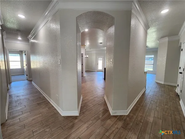 a view of an empty room with a fireplace and a window