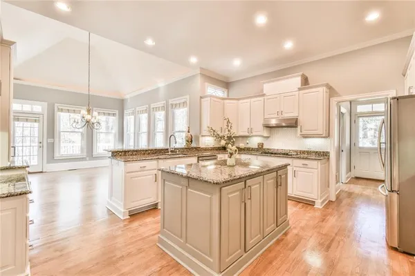 a kitchen with a sink stove and cabinets