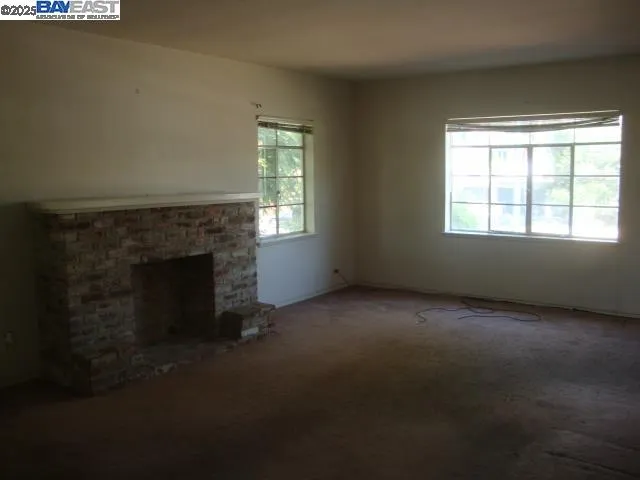 an empty room with a fireplace