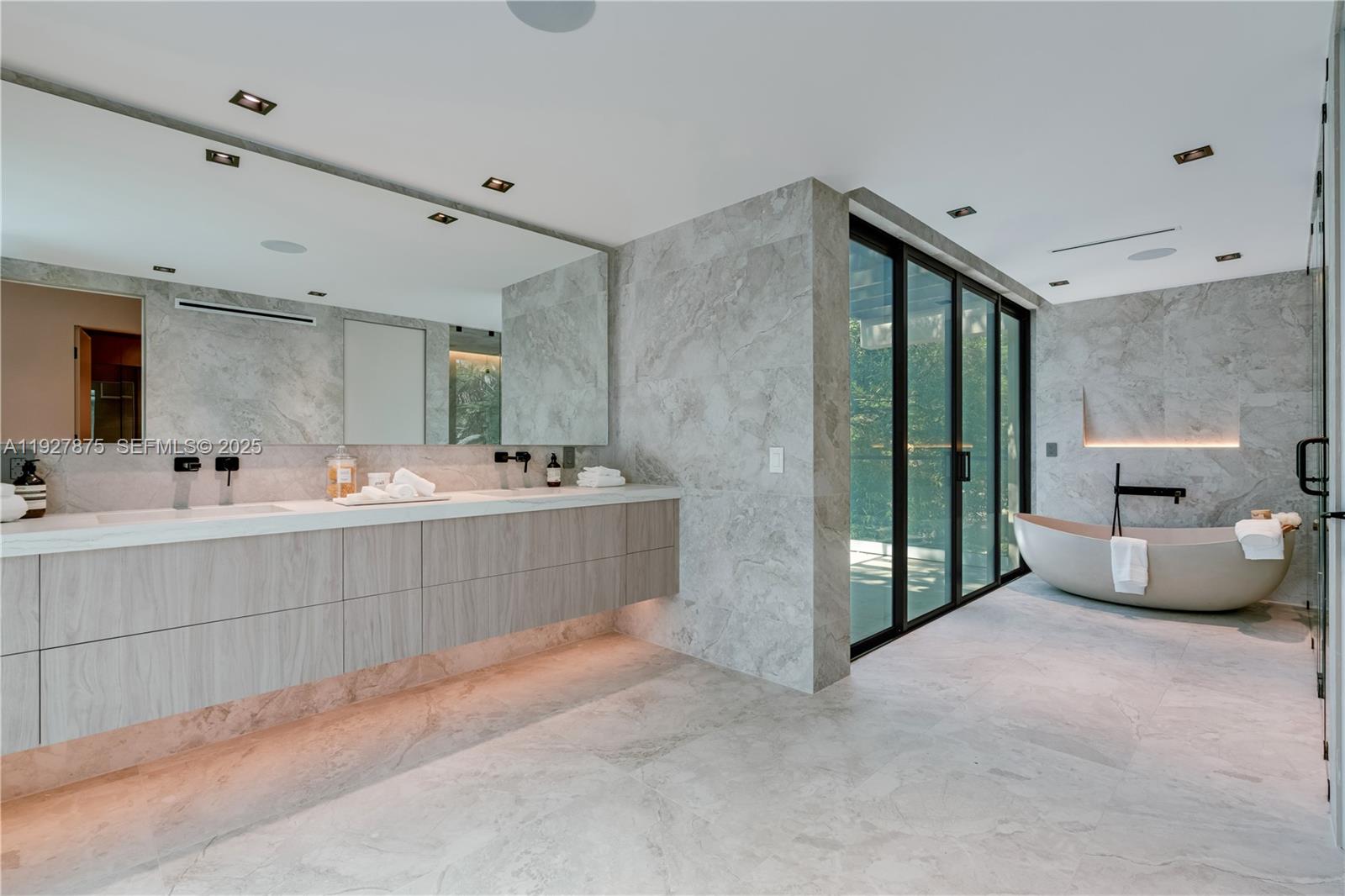 2800 Calusa Street Miami, FL 33133 - Photo 44 of 71 a bathroom with a double vanity sink mirror and bathtub