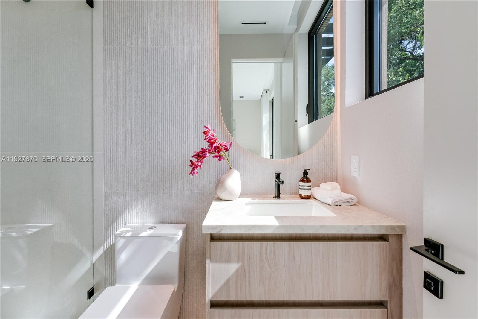 2800 Calusa Street Miami, FL 33133 - Photo 52 of 71 a bathroom with a sink vanity and a mirror