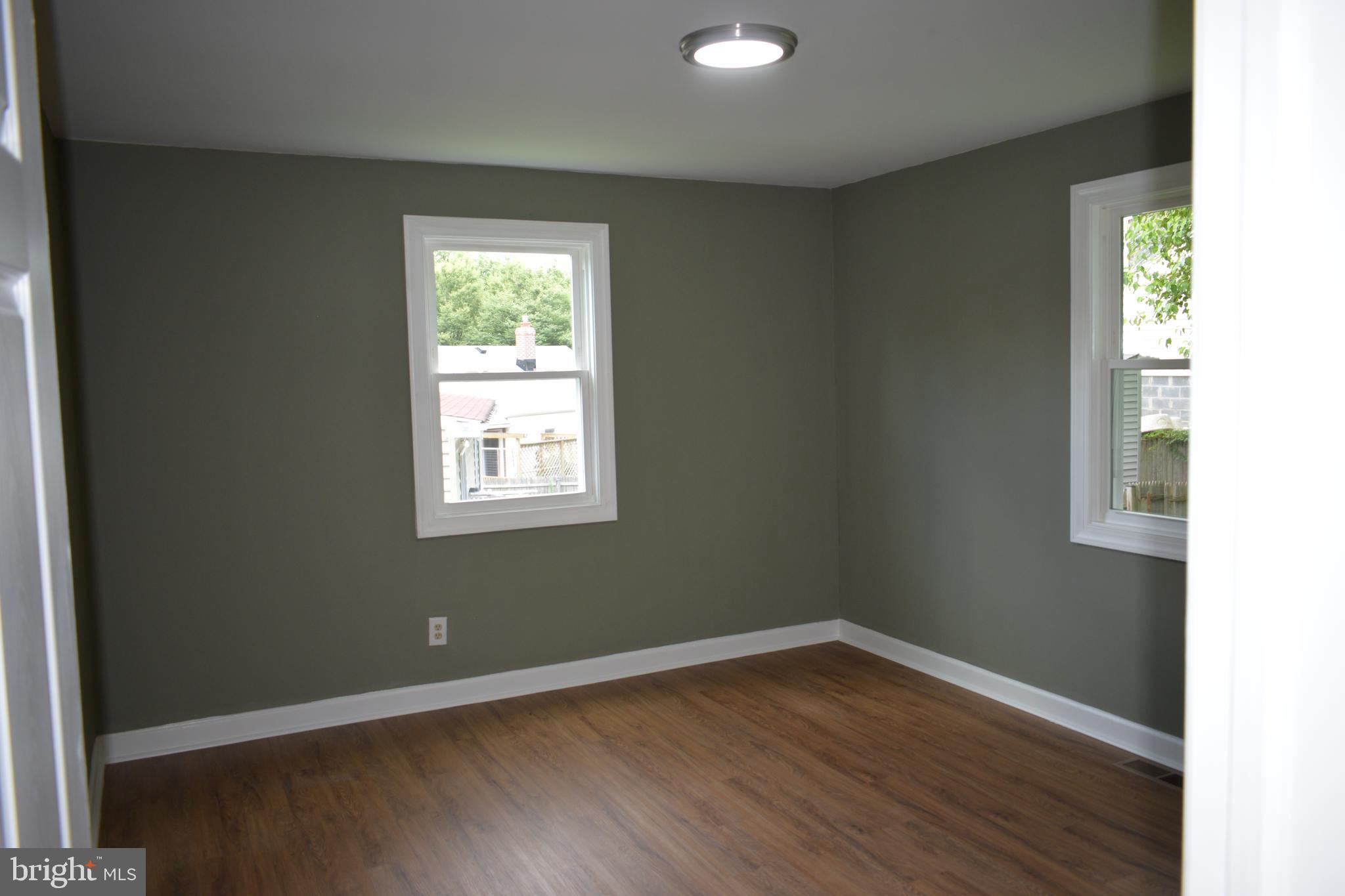 12323 Dewey Silver Spring Silver Spring, MD 20906 - Photo 15 of 37 an empty room with wooden floor and windows