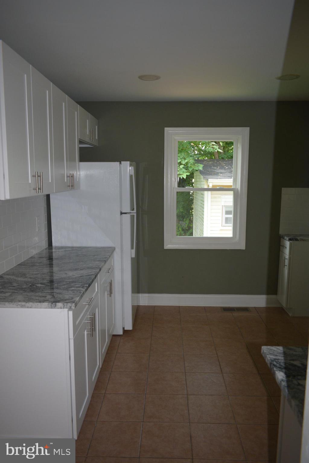 12323 Dewey Silver Spring Silver Spring, MD 20906 - Photo 17 of 37 a kitchen with granite countertop a sink a stove and a refrigerator