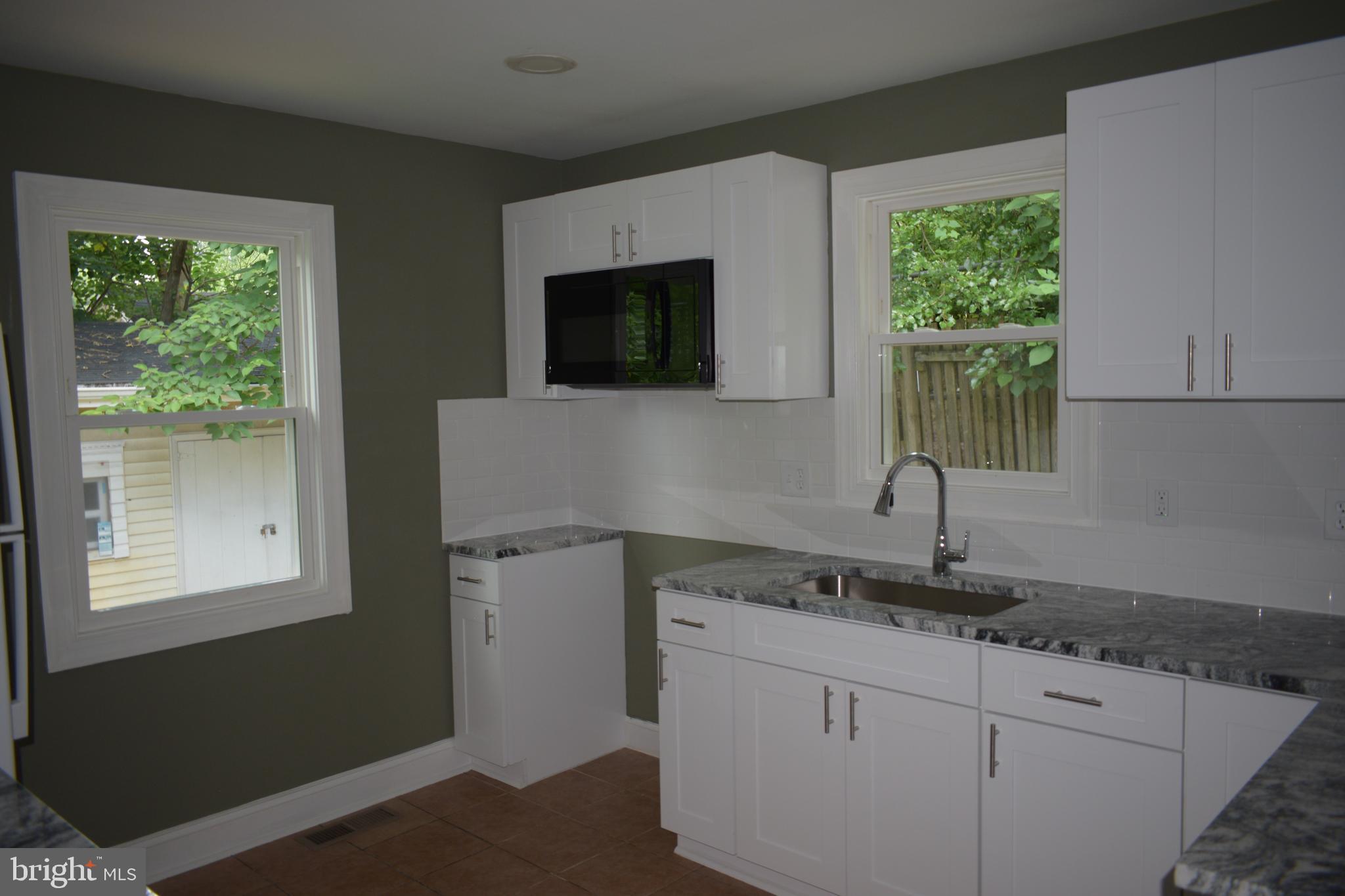 12323 Dewey Silver Spring Silver Spring, MD 20906 - Photo 18 of 37 a kitchen with sink cabinets and window