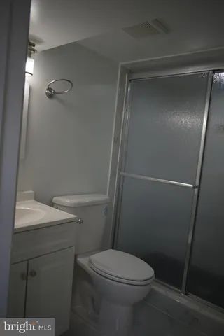 a white toilet sitting next to a bathroom sink