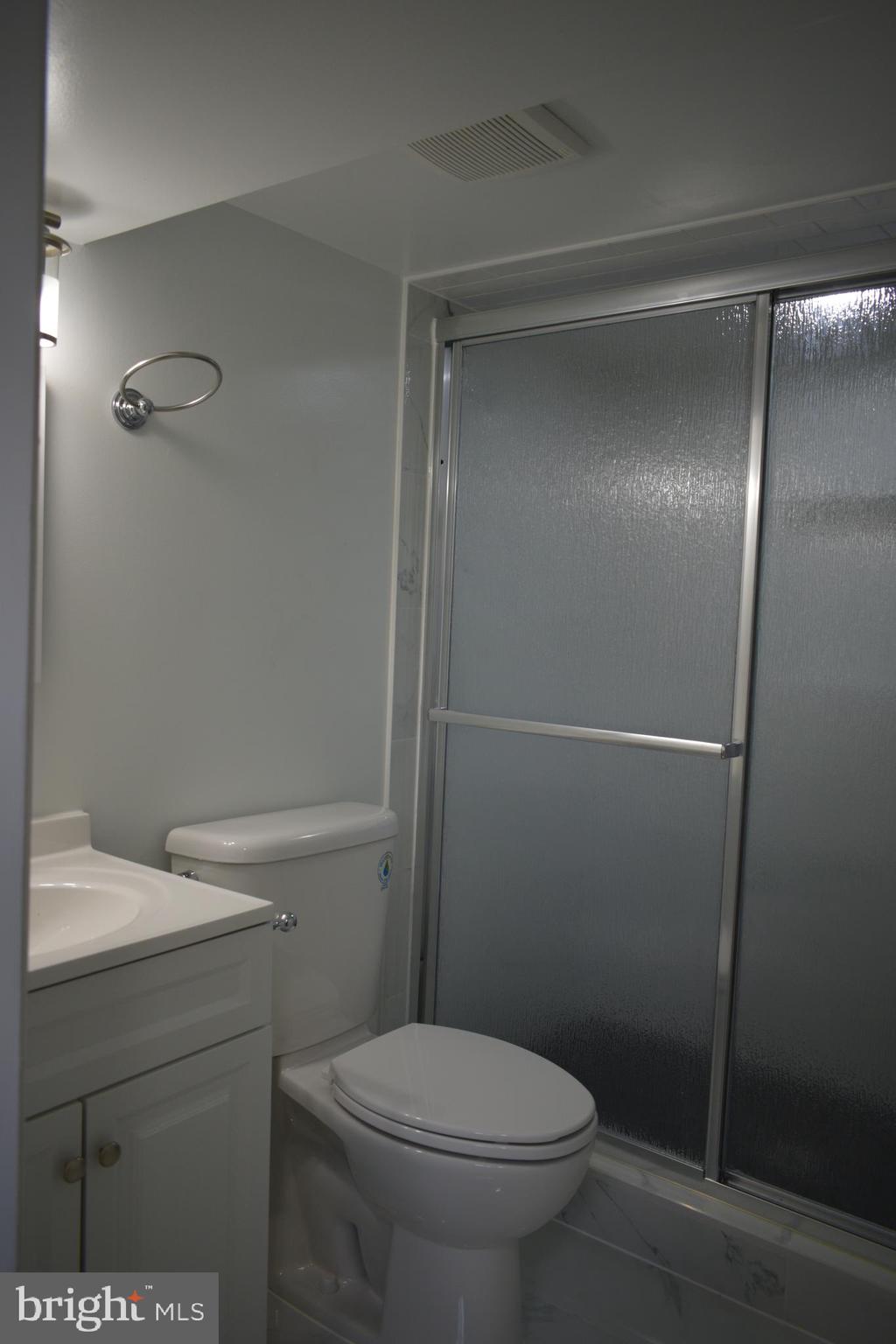 12323 Dewey Silver Spring Silver Spring, MD 20906 - Photo 30 of 37 a white toilet sitting next to a bathroom sink