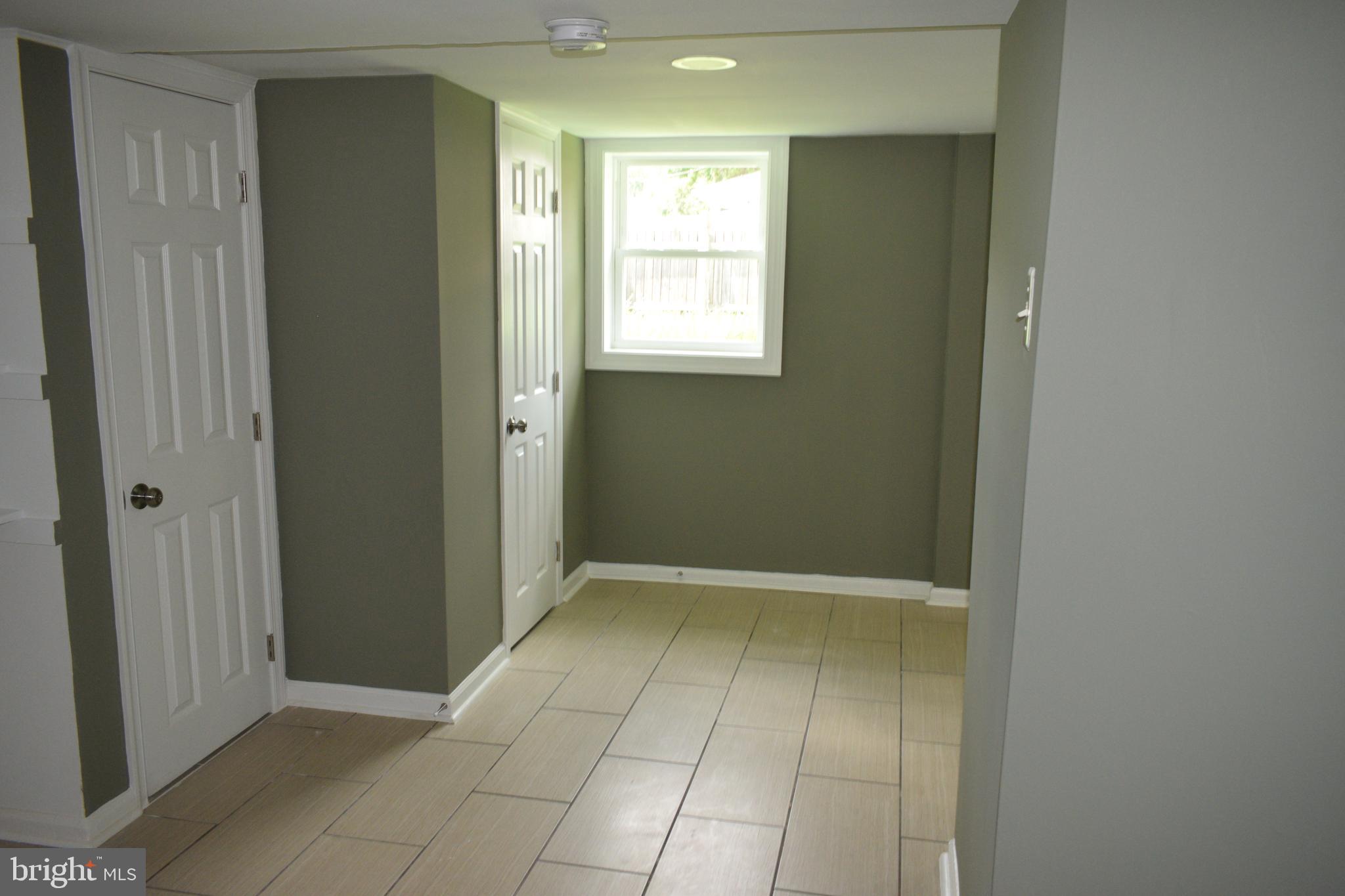 12323 Dewey Silver Spring Silver Spring, MD 20906 - Photo 31 of 37 a view of an empty room with window and bathroom
