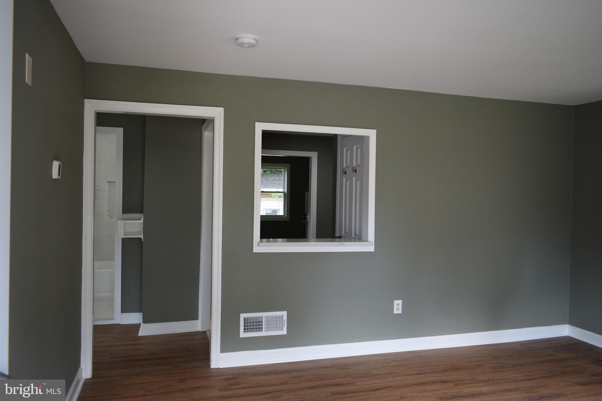 12323 Dewey Silver Spring Silver Spring, MD 20906 - Photo 9 of 37 a view of an empty room with wooden floor and a window