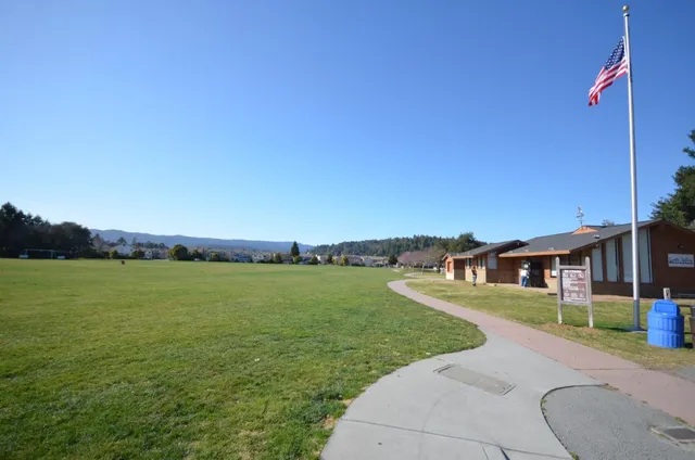 a view of a swimming pool with a table and chairs