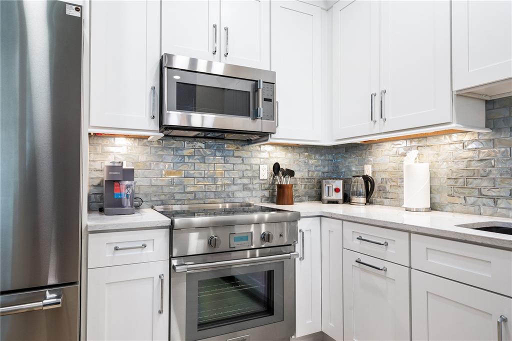 1234 15th Street, Unit 102 Sarasota, FL 34236 - Photo 12 of 30 a kitchen with stainless steel appliances white cabinets and a sink