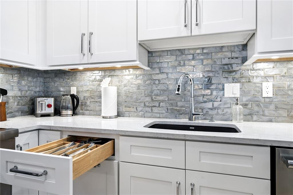 1234 15th Street, Unit 102 Sarasota, FL 34236 - Photo 13 of 30 a kitchen with granite countertop a sink a stove and cabinets