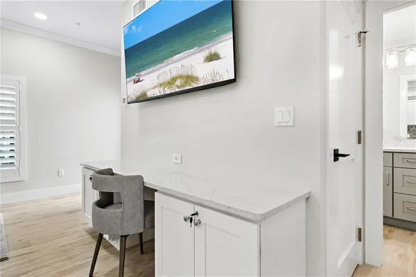 a room with wooden floor and cabinet
