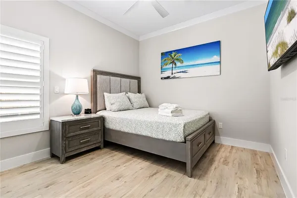 a bedroom with a bed and a painting on the wall
