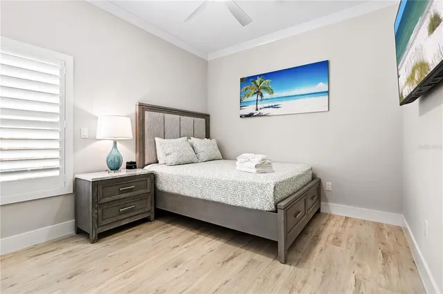 a bedroom with a bed and a painting on the wall
