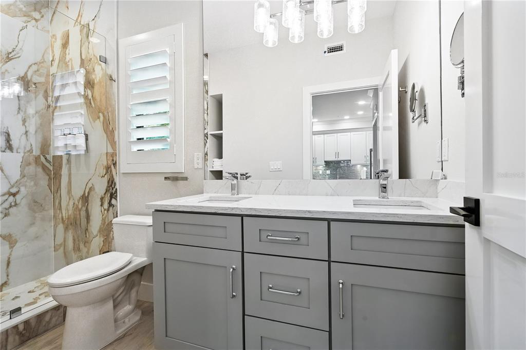 1234 15th Street, Unit 102 Sarasota, FL 34236 - Photo 19 of 30 a bathroom with a double vanity sink mirror and toilet