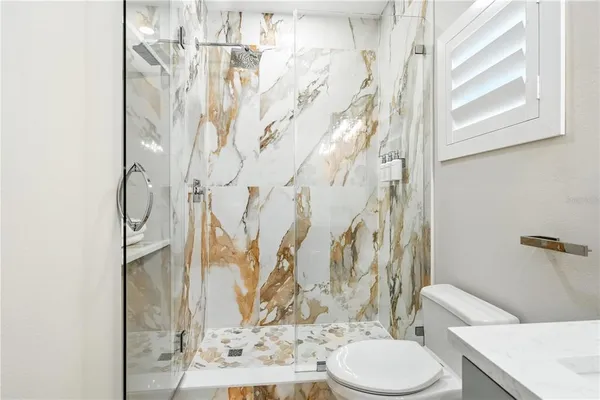 a bathroom with a toilet sink and shower curtain