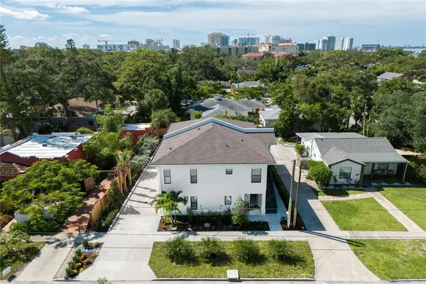 a aerial view of a house with a yard and a fountain