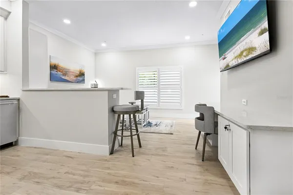 a workspace with furniture and paintings on the wall