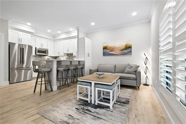 a living room with stainless steel appliances kitchen island granite countertop furniture and a kitchen view
