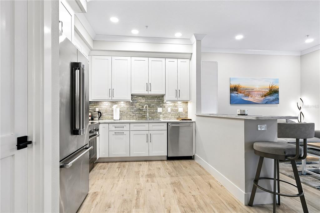 1234 15th Street, Unit 102 Sarasota, FL 34236 - Photo 10 of 30 a kitchen with granite countertop a refrigerator stove top oven and sink